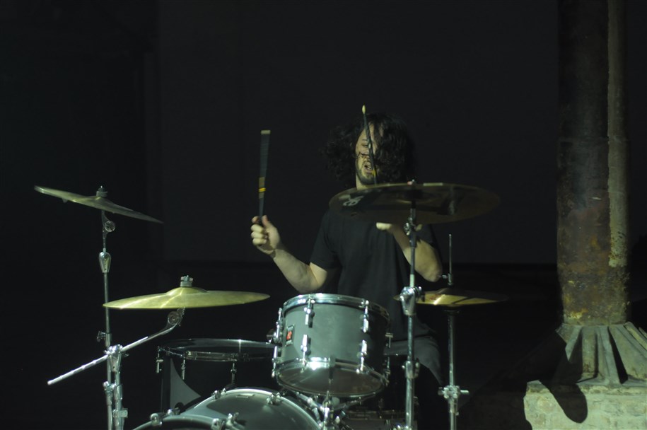 Nahuel Arias playing a drum kit on stage
