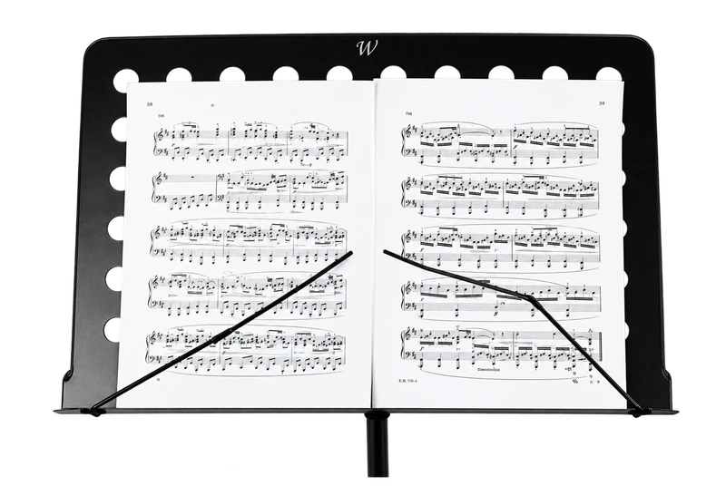 Music stand holding an open book of musical notation